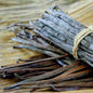 Bundled vanilla beans on a wooden surface